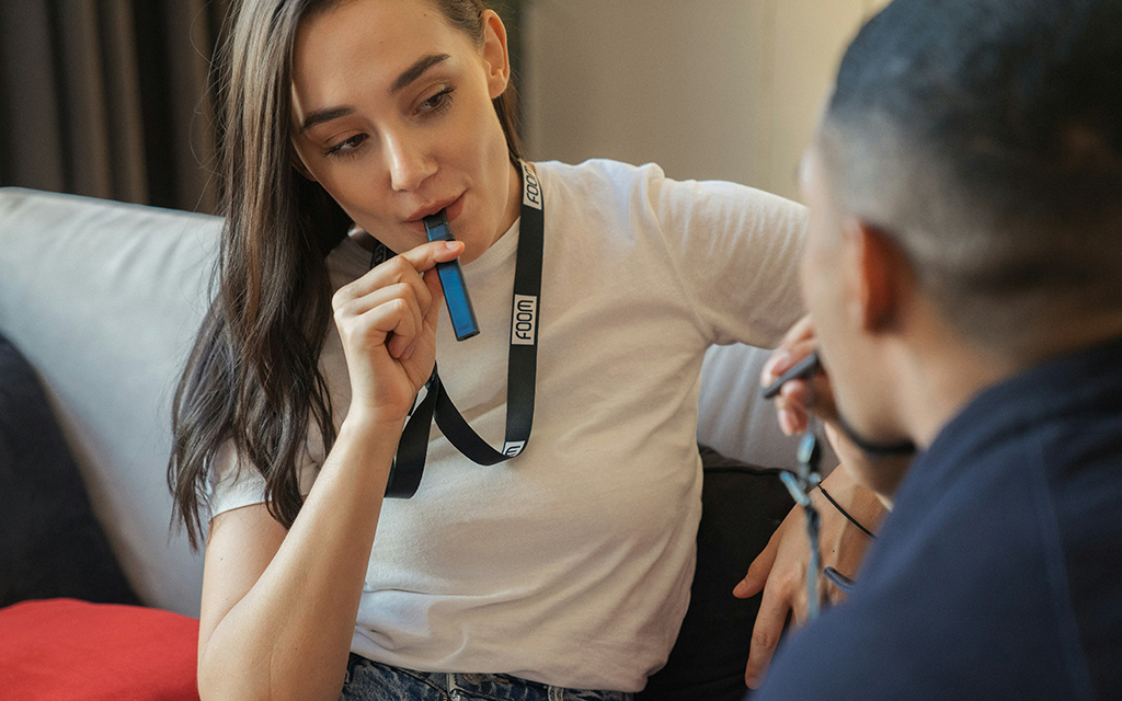 Woman and man are vaping disposable vape